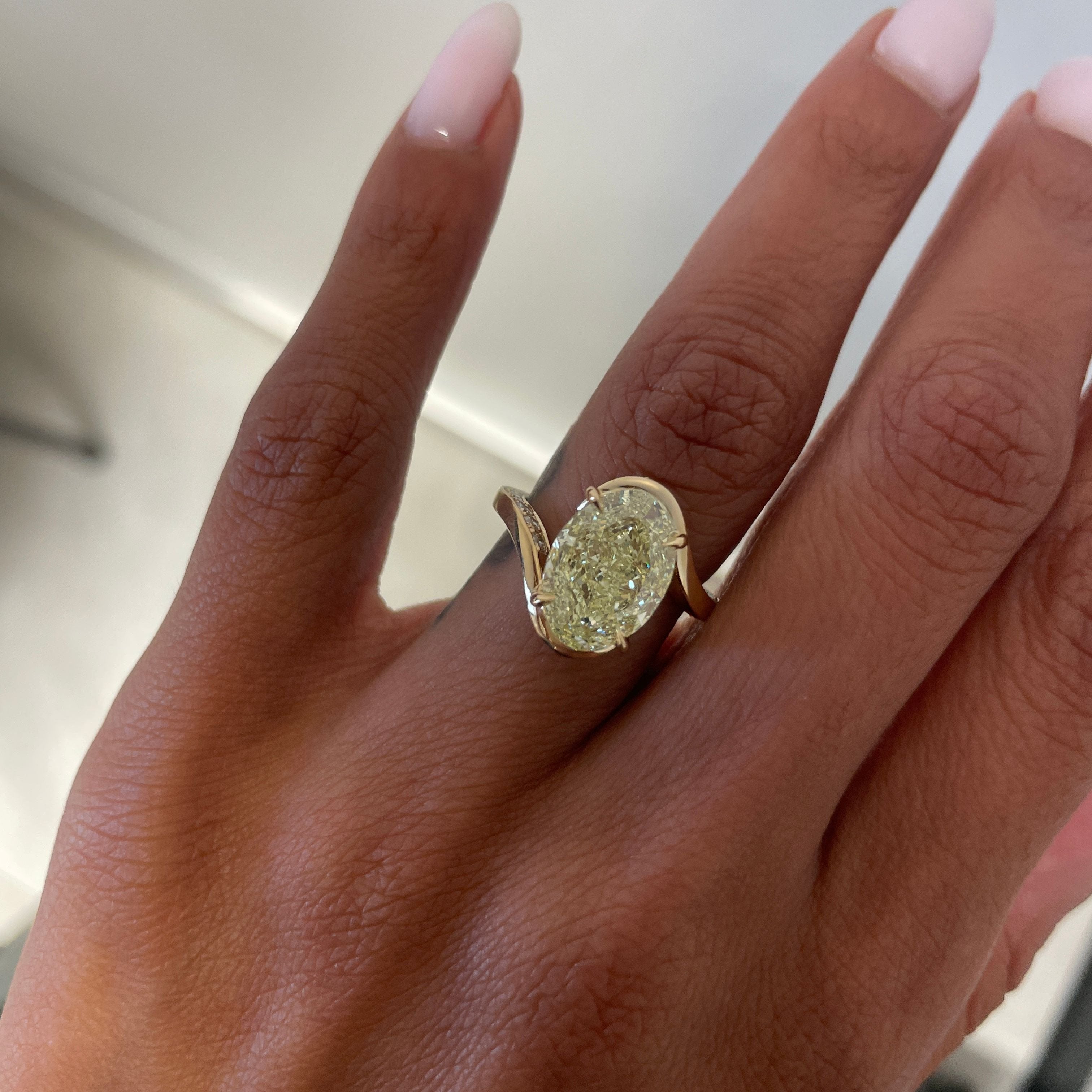Yellow Oval Diamond in Wave Setting with Pavé in band on hand