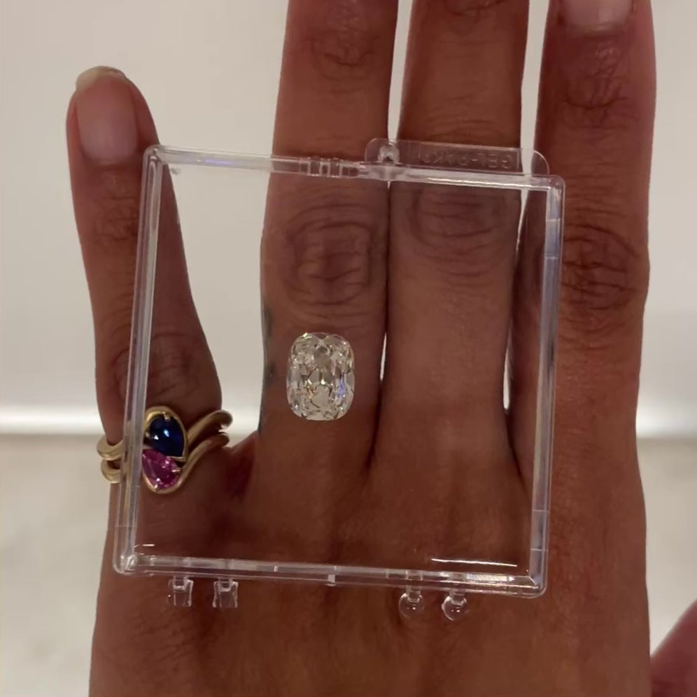 Video of 4.56 M color Cushion Diamond in Gel Case, next to a bb thelma blue and pink sapphire pinky ring stack.