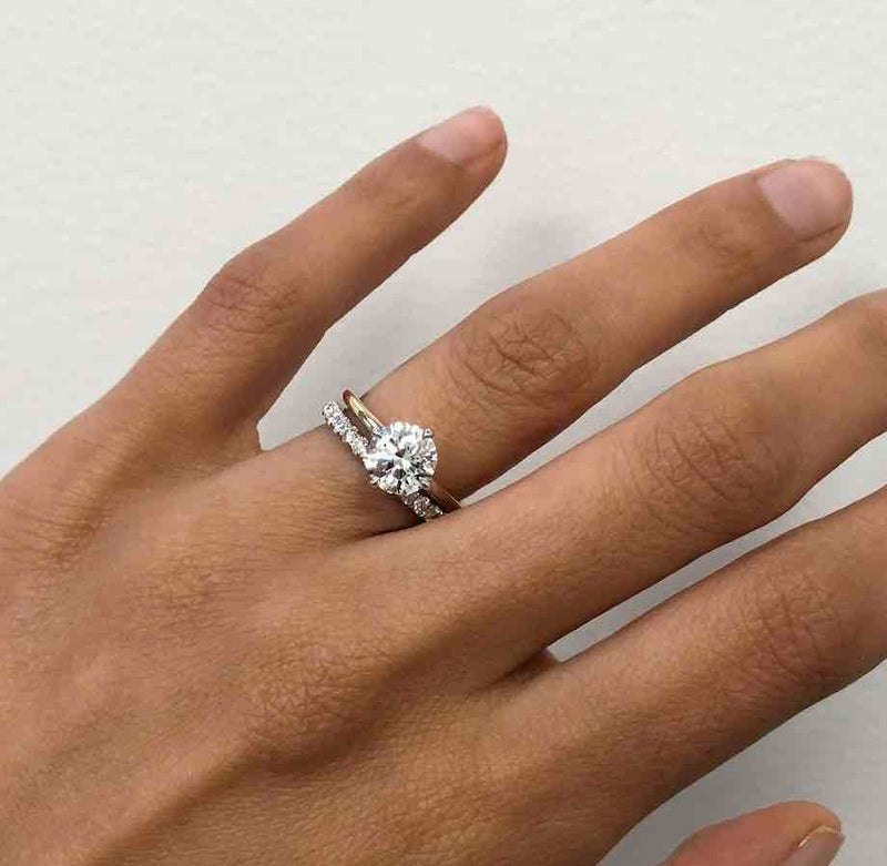 AARYAH Reset into Round Diamond Solitaire, with eternity wedding band on finger