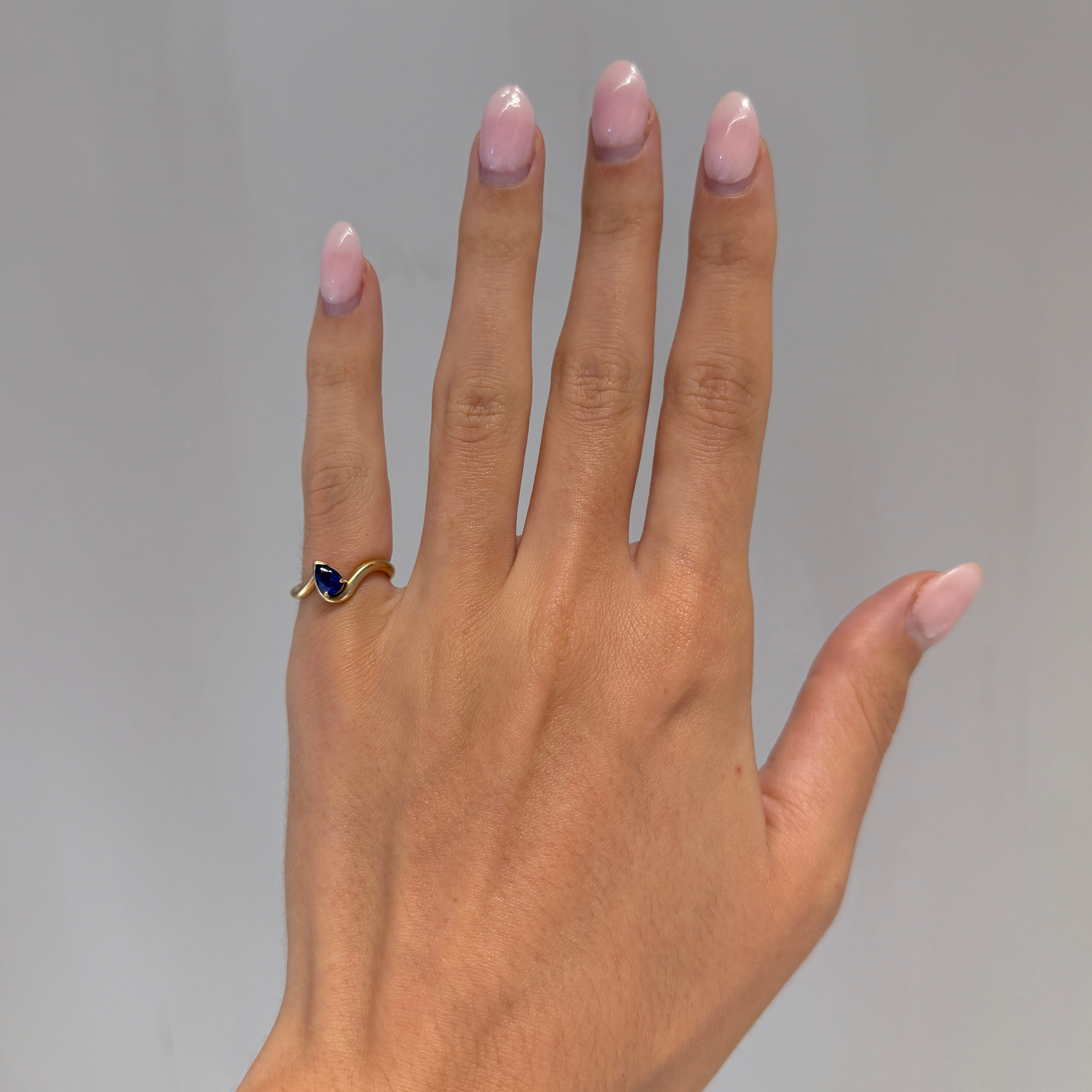 BB Thelma Blue Sapphire pinky ring on hand, 14k yellow gold