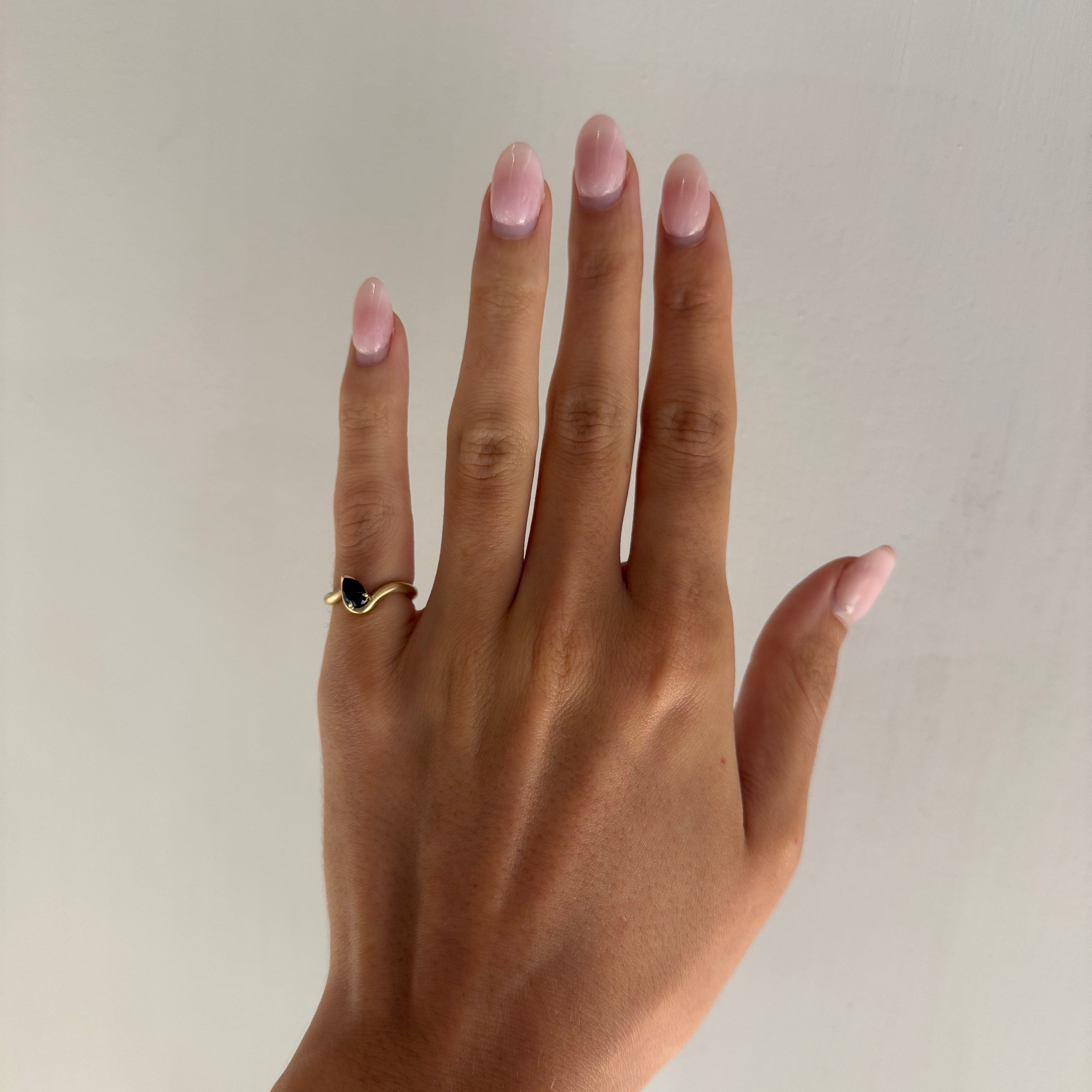 BB Thelma pinky ring Onyx on hand model in front of white wall.