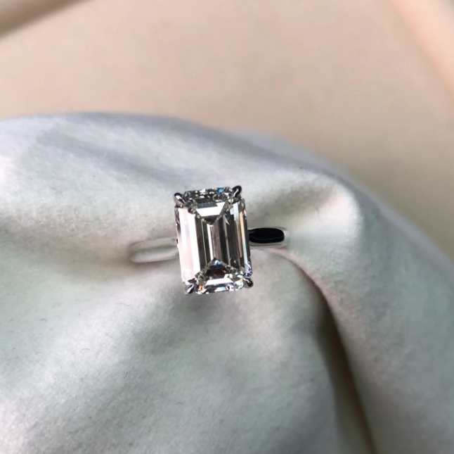 Bespoke Emerald Cut Solitaire Ring, held with fabric