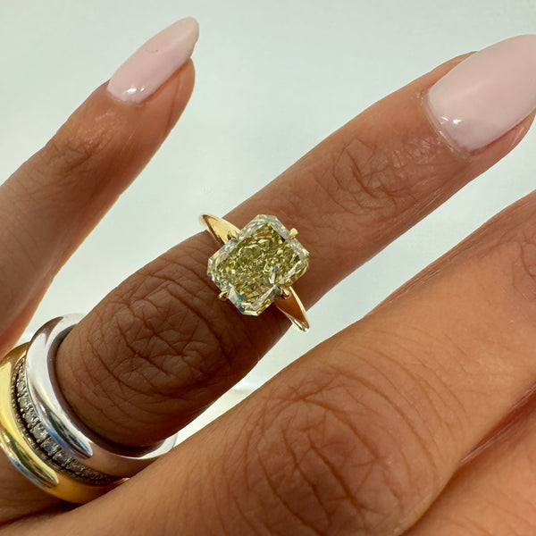 Modified MAE with a Yellowish Brown Radiant Cut Diamond, on finger, close up