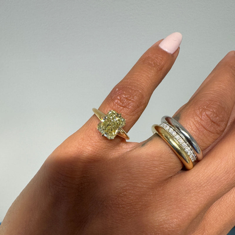 Modified Mae with Yellowish Brown Radiant Cut Diamond, worn on pinkie next to band stacks